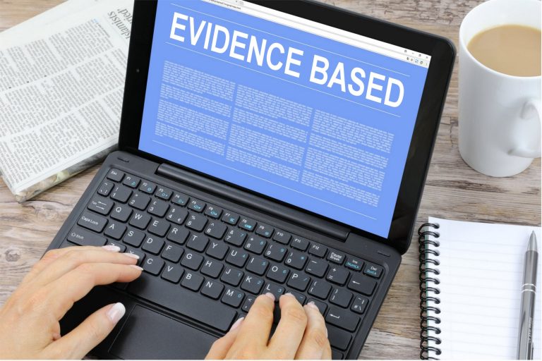 Image of laptop saying "Evidence Based"